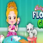 Fetiță blondă îmbrăcată în rochie roz stând la o masă cu obiecte de machiaj și o pisicuță albă pe un scaun, pe un fundal verde cu text colorat