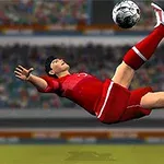 Fotbalist în echipament roșu executând o foarfecă pe teren, cu tribune în fundal