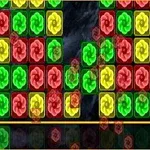 Blocuri colorate de roșu, galben și verde cu simboluri în formă de flori rotative pe un fundal întunecat