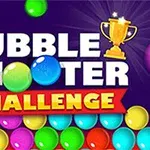 „Bubble Shooter Challenge” scris cu litere alb și galben pe un fundal mov, completat de un trofeu auriu și bile colorate în partea de jos