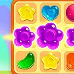 Forme de bomboane colorate pe o tablă de joc cu fundal albastru și mov