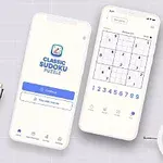 Două telefoane mobile afișează o aplicație de puzzle Sudoku, alături de un ceas alb și o plantă verde pe un birou