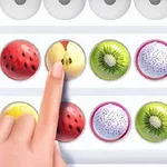Un deget selectează o bilă cu imagine de măr într-un rând de bile cu imagini de fructe, inclusiv căpșuni, kiwi și fructul dragonului, însoțite de marcaje circulare alb-negru pe lateral