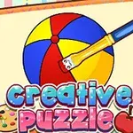 O minge colorată pe un caiet de desen cu o pensulă și cuvintele creative puzzle în partea de jos