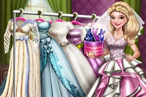 O femeie zâmbitoare în rochie de mireasă alături de o serie de rochii elegante pe un suport, ținând o cutie cu sticle colorate