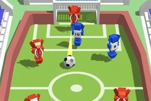 Joc de fotbal cu jucători stilizați în roșu și albastru pe un teren mic, cu o minge în mișcare spre poartă