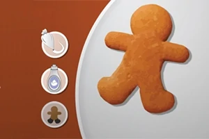 Om de turtă dulce pe o farfurie, cu trei cercuri mici în stânga, conținând instrumente de decorare