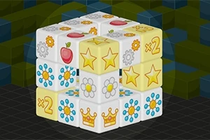 Cub 3D compus din blocuri decorate cu diferite simboluri colorate, inclusiv stele, coroane, flori și mere