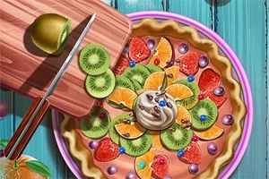 Tartă decorată cu felii de kiwi, portocale, căpșuni și frișcă, lângă un tocător cu un cuțit și kiwi tăiat pe un fundal albastru
