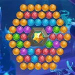 Bile colorate aranjate circular în jurul unei pietre centrale, pe un fundal subacvatic