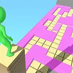 Un personaj verde dintr-un joc stă pe o grămadă de plăci lângă un traseu colorat cu roz și galben