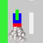 Un obiect format din blocuri colorate verde, albastru și roșu pe un drum gri cu margini verzi și bile albe în spatele său