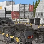 Camion alb parcat într-un depozit cu containere colorate și baricade galbene
